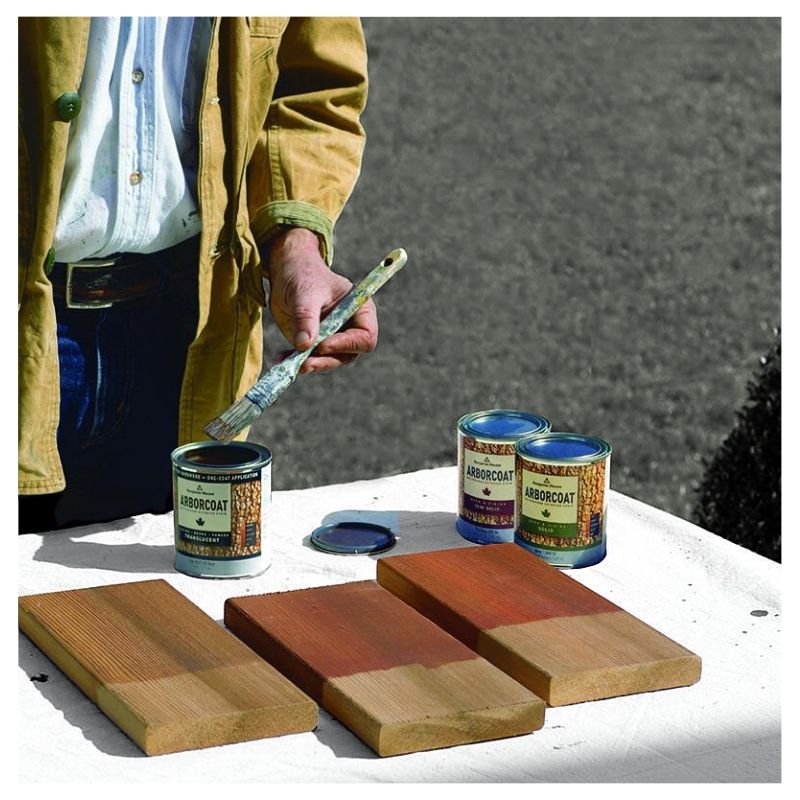 man using benjamin moore exterior stain outside to sample some colors on wood