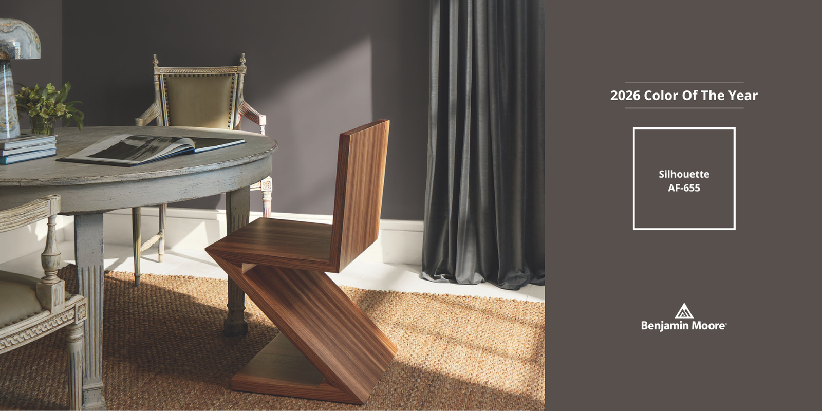 Benjamin Moore Silhouette AF-655 paint swatch on a wall with a window and decorative elements.